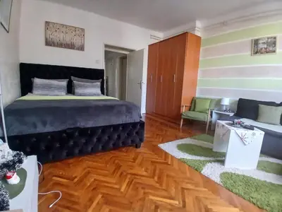 a bedroom with a bed and a couch at Nada Sweet House in Belgrade