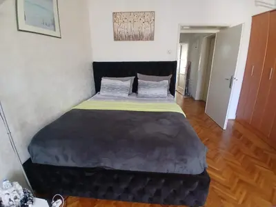 a bedroom with a large bed in a room at Nada Sweet House in Belgrade