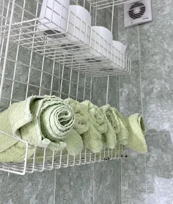 a rack with green towels and white towels at Nada Sweet House in Belgrade