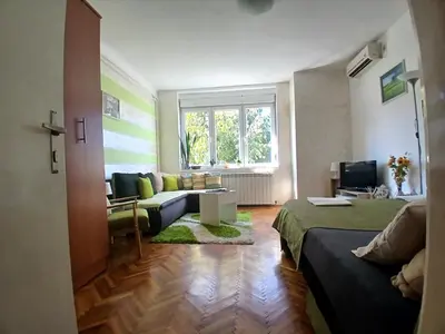 a living room with a bed and a couch at Nada Sweet House in Belgrade