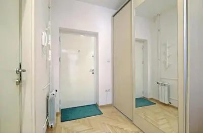 a large mirror in a room with a hallway at Cozy apartment near Saint Sava Temple in Belgrade