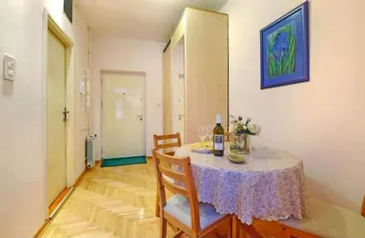 a dining room with a table with a bottle of wine at Cozy apartment near Saint Sava Temple in Belgrade