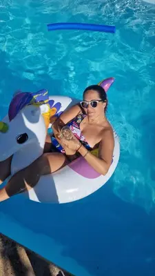 a woman in sunglasses sitting on an inflatable at Vila Vista Verde in Zaklopača