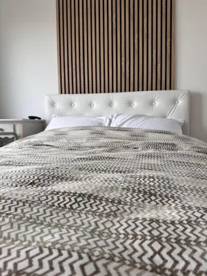 a large bed with a black and white comforter at Vila Vista Verde in Zaklopača