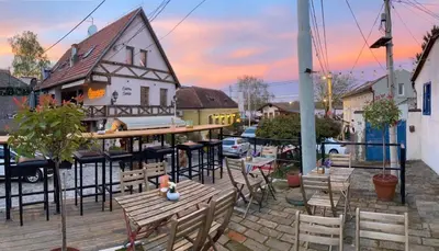 a patio with a table and chairs and a building at Zemun Riverside in Zemun