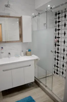 a bathroom with a white sink and a shower at Classy and cozy near Tasmajdan park and Flower Piazza in Belgrade