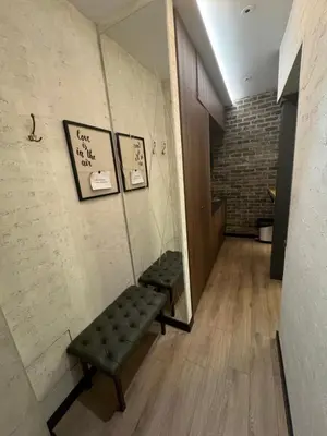 a hallway with two green benches in a room at Apartment Despot in Belgrade
