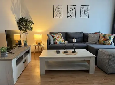 a living room with a couch and a coffee table at Caravaggio Apartman in Mladenovac