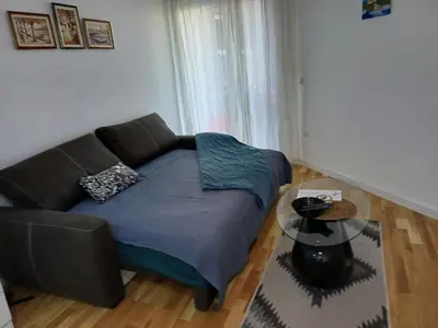 a living room with a couch and a table at Amazing apartment in Zemun