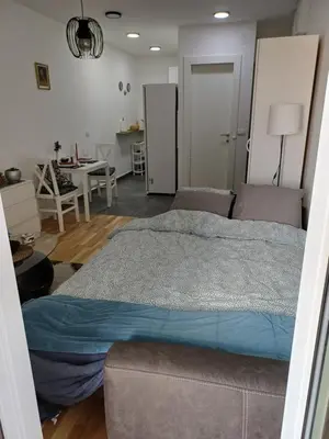 a bedroom with a large bed and a table at Amazing apartment in Zemun