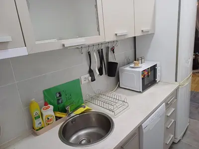 a kitchen counter with a sink and a microwave at Amazing apartment in Zemun