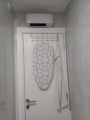 a bathroom with a white door with a hoodie and aperature at Amazing apartment in Zemun