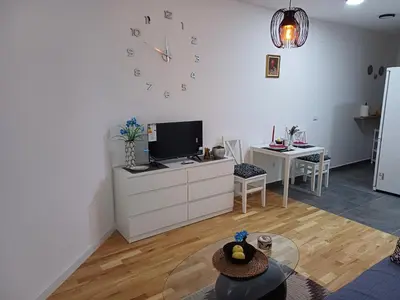 a living room with a large clock on the wall at Amazing apartment in Zemun