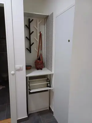 a walk in closet with white shelves at Amazing apartment in Zemun