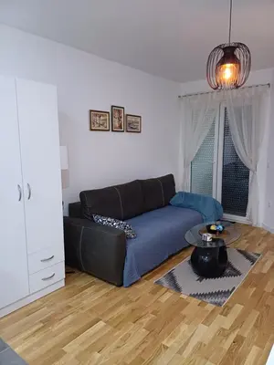 a living room with a couch and a table at Amazing apartment in Zemun