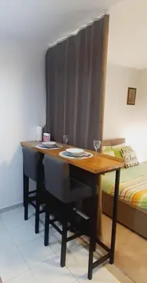 a table in a room next to a bed at BRAND NEW Entire Place in CENTER of ZEMUN in Belgrade