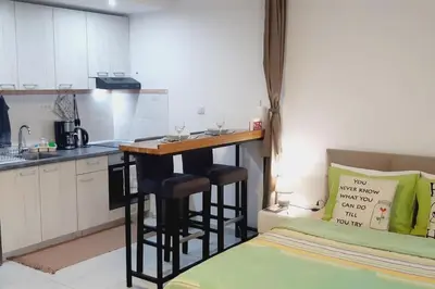 a kitchen with a bar in the middle of a room at BRAND NEW Entire Place in CENTER of ZEMUN in Belgrade