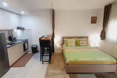 a small room with a bed and a kitchen at BRAND NEW Entire Place in CENTER of ZEMUN in Belgrade