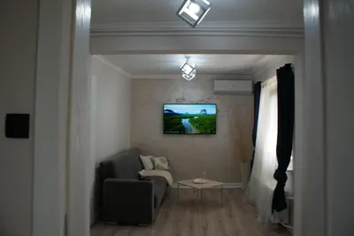 a living room with a couch and a tv on the wall at Apartmani Djordjevic in Belgrade
