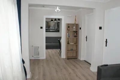a living room with white walls and wooden floors at Apartmani Djordjevic in Belgrade