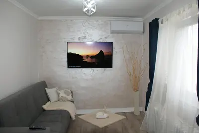 a living room with a couch and a picture on the wall at Apartmani Djordjevic in Belgrade