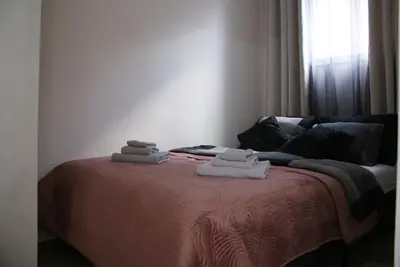 a bedroom with a bed with towels on it at Apartmani Djordjevic in Belgrade
