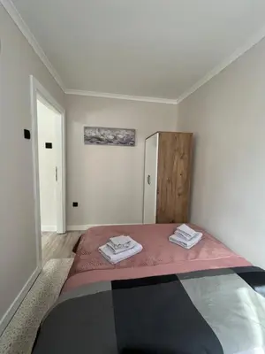 a bedroom with a bed with two towels on it at Apartmani Djordjevic in Belgrade