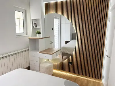 a bedroom with a bed and a large mirror at Central Elegance in Belgrade