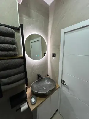a bathroom with a sink and a mirror at Central Elegance in Belgrade