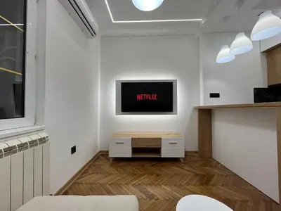 a living room with a tv on a wall at Central Elegance in Belgrade