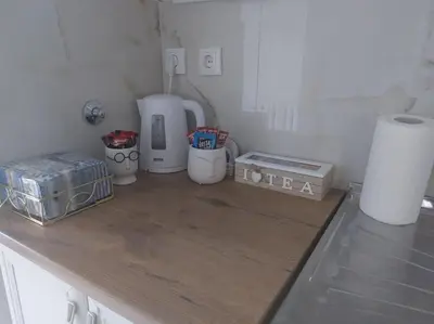 a kitchen with a counter top with appliances on it at Toni apartments in Voždovac