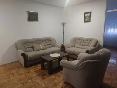 a living room with two couches and a table at Toni apartments in Voždovac