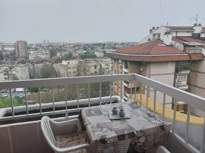 a balcony with a table and chairs on a balcony at Toni apartments in Voždovac