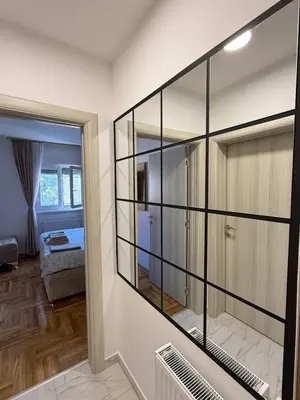 a room with a large glass wall at Golden dream apartman in Pančevo
