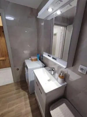 a bathroom with a sink and a mirror at Golden dream apartman in Pančevo