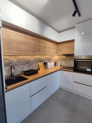 a kitchen with white cabinets and a sink and a microwave at Golden dream apartman in Pančevo