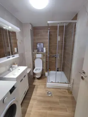 a bathroom with a shower and a toilet and a sink at Golden dream apartman in Pančevo