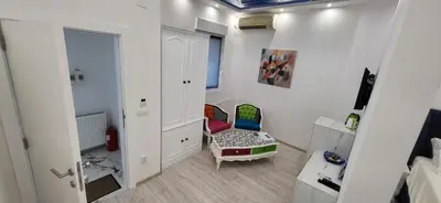 a white room with a chair and a mirror at Bumerang Apartmans, New Belgrade, Belgrade Arena in Belgrade