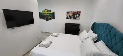 a hotel room with a bed and a flat screen tv at Bumerang Apartmans, New Belgrade, Belgrade Arena in Belgrade