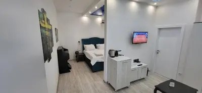 a small room with a bed and a table in it at Bumerang Apartmans, New Belgrade, Belgrade Arena in Belgrade