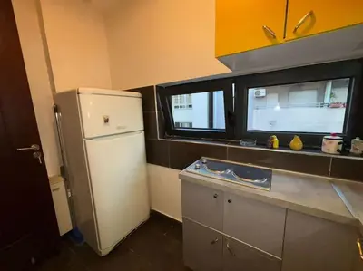 a kitchen with a white refrigerator and a window at Belgrade Center Apartment Studio in Belgrade