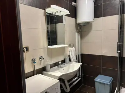 a bathroom with a sink and a mirror at Belgrade Center Apartment Studio in Belgrade