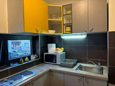 a kitchen with a sink and a microwave at Belgrade Center Apartment Studio in Belgrade