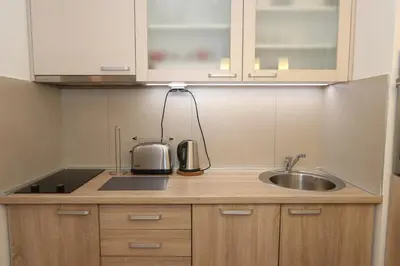 a kitchen counter with a sink and a microwave at Savada Delta City - stan na dan Novi Beograd in Belgrade