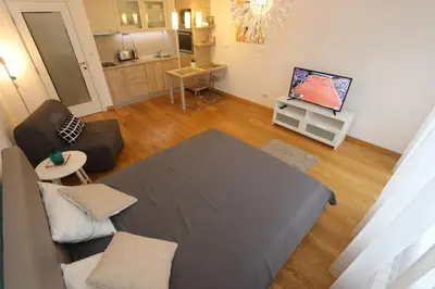 a small living room with a couch and a tv at Savada Delta City - stan na dan Novi Beograd in Belgrade
