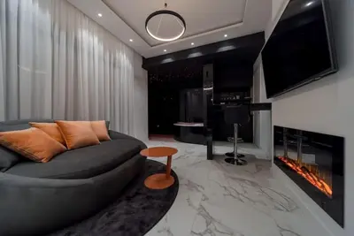 a living room with a couch and a fireplace at Bounce Belgrade Apartment in Vračar (historical)