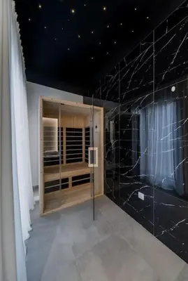 a bathroom with black marble walls and a window at Bounce Belgrade Apartment in Vračar (historical)