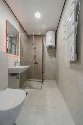 a bathroom with a shower and a toilet and a sink at Bounce Belgrade Apartment in Vračar (historical)