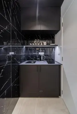 a black kitchen with a sink and a counter at Bounce Belgrade Apartment in Vračar (historical)