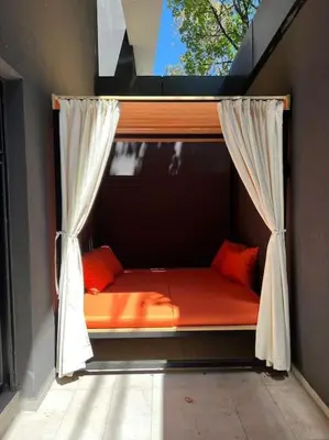 a bed in a room with a window at Bounce Belgrade Apartment in Vračar (historical)